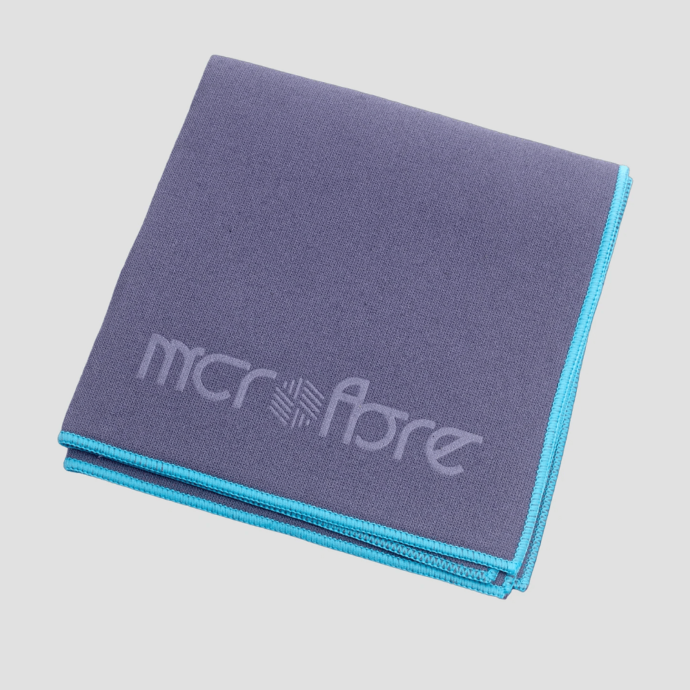 Folded car glass microfibre cloth with 'mcrofbre' branding on a light grey background