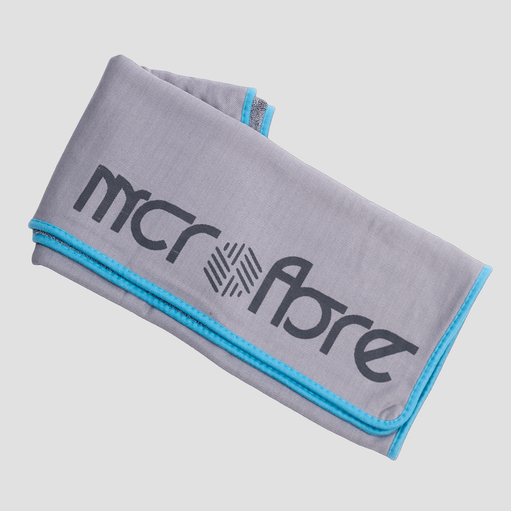 Grey car microfibre drying towel towel with blue edges on a light grey background