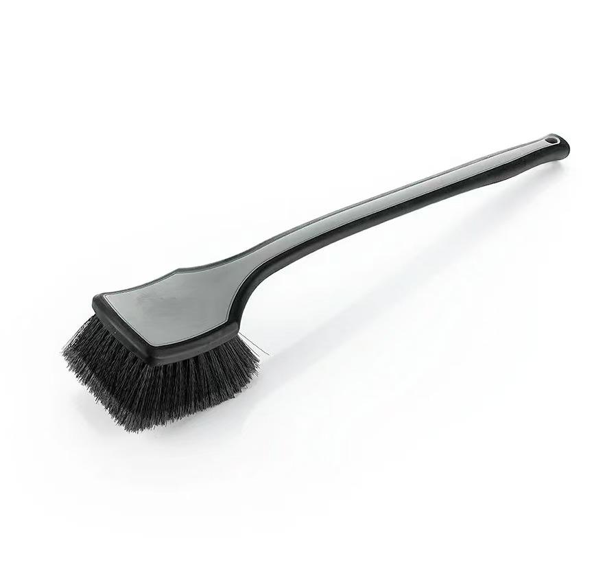A black bristle car cleaning brush with a long handle, used for car cleaning and cleaning car wheels and arches