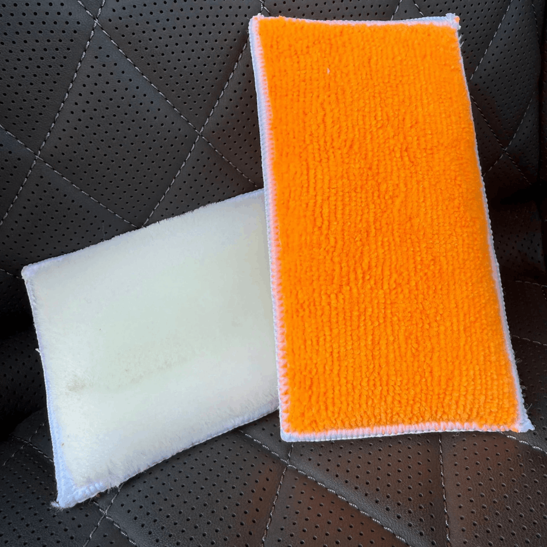 Dual-sided car detailing wash pad with soft white microfibre and orange cleaning surface, designed for safe and effective vehicle washing.