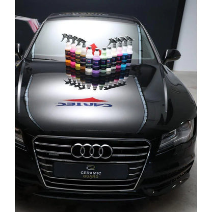 Car hood a cartec car care products on display on a black Audi vehicle.