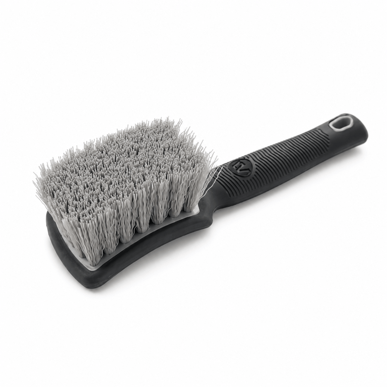 Grey tyre cleaning brush with a black ergonomic handle for car cleaning