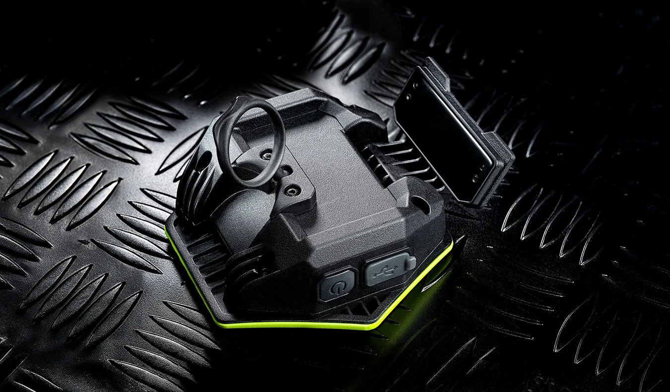 Compact Unilite HX-1080 LED detailing light with high-visibility green surround, ideal for car detailing, inspection and workshop use.