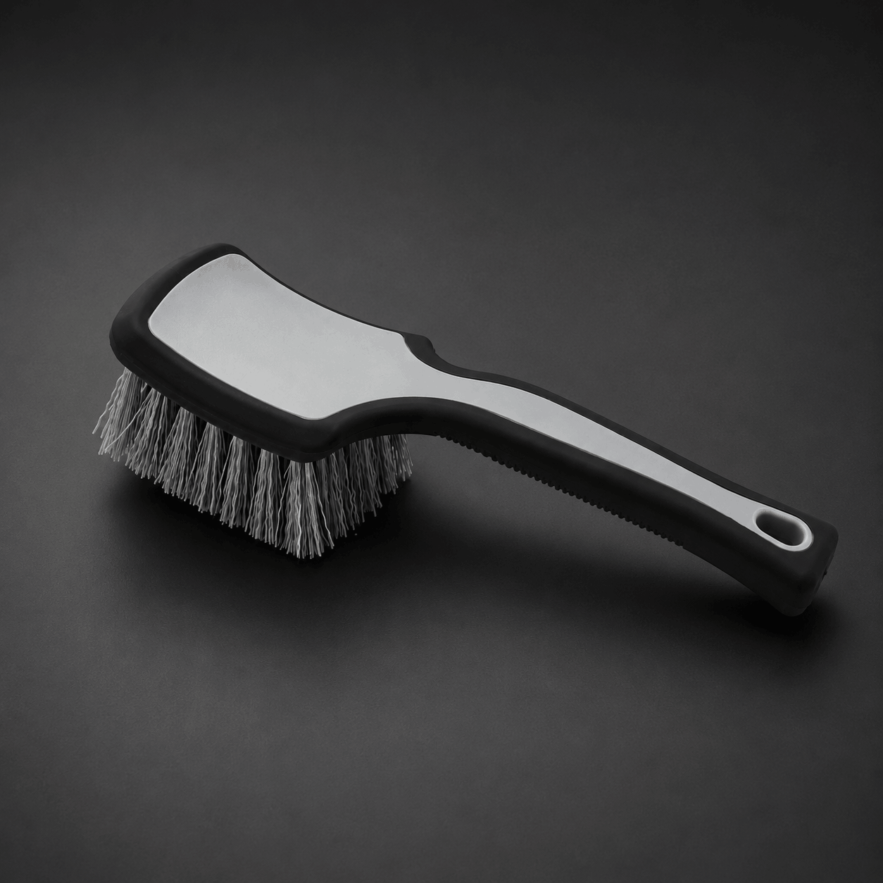 Tyre cleaning brush with a ergonomic black handle and bristle head for car cleaning and detailing