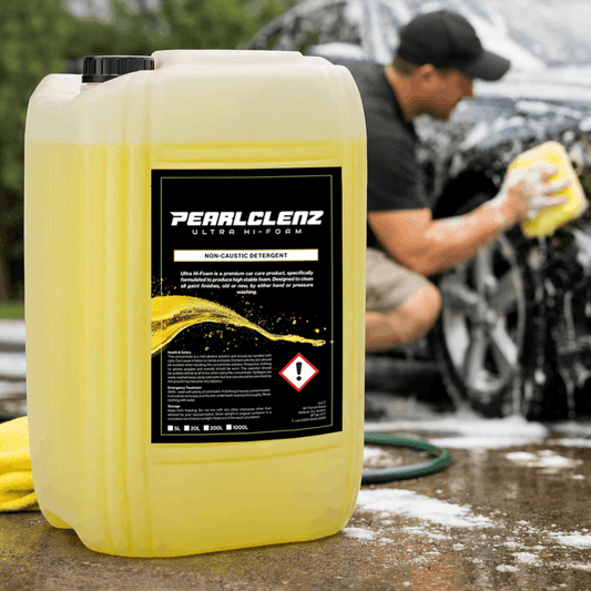 Pearlclenz Ultra Hi-Form Non-Cardiac Detergent with a background of a man washing a car outdoors.