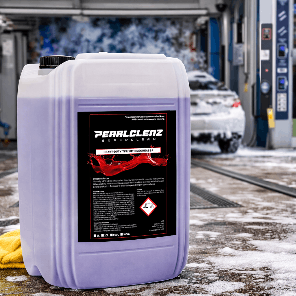 Pearlclenz Superclean Heavy-Duty TFR with Degreaser for professional vehicle cleaning, shown in a commercial car wash with a foam-covered vehicle in the background.