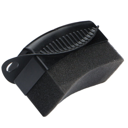 Black car tyre dressing applicator with a dual-sided design featuring a textured foam sponge block and a ribbed plastic scraper edge.