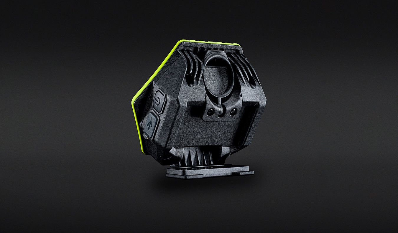 Unilite HX-1080 rechargeable LED work light with bright green protective casing, mounted on a black workshop panel.