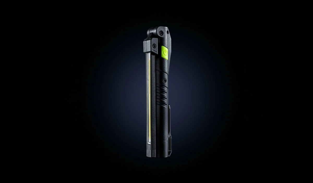 Unilite rechargeable LED inspection light held in a work glove for professional body shop.