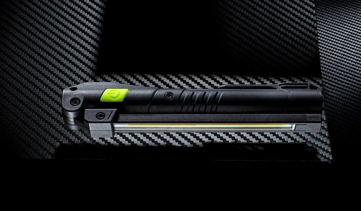 Unilite rechargeable LED inspection light held in a work glove for professional electrical work.