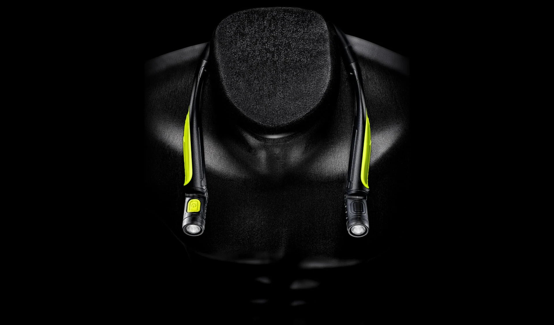 Unilite rechargeable neck light with dual adjustable LED lights and high-visibility green detailing, designed for hands-free workshop and car detailing use.